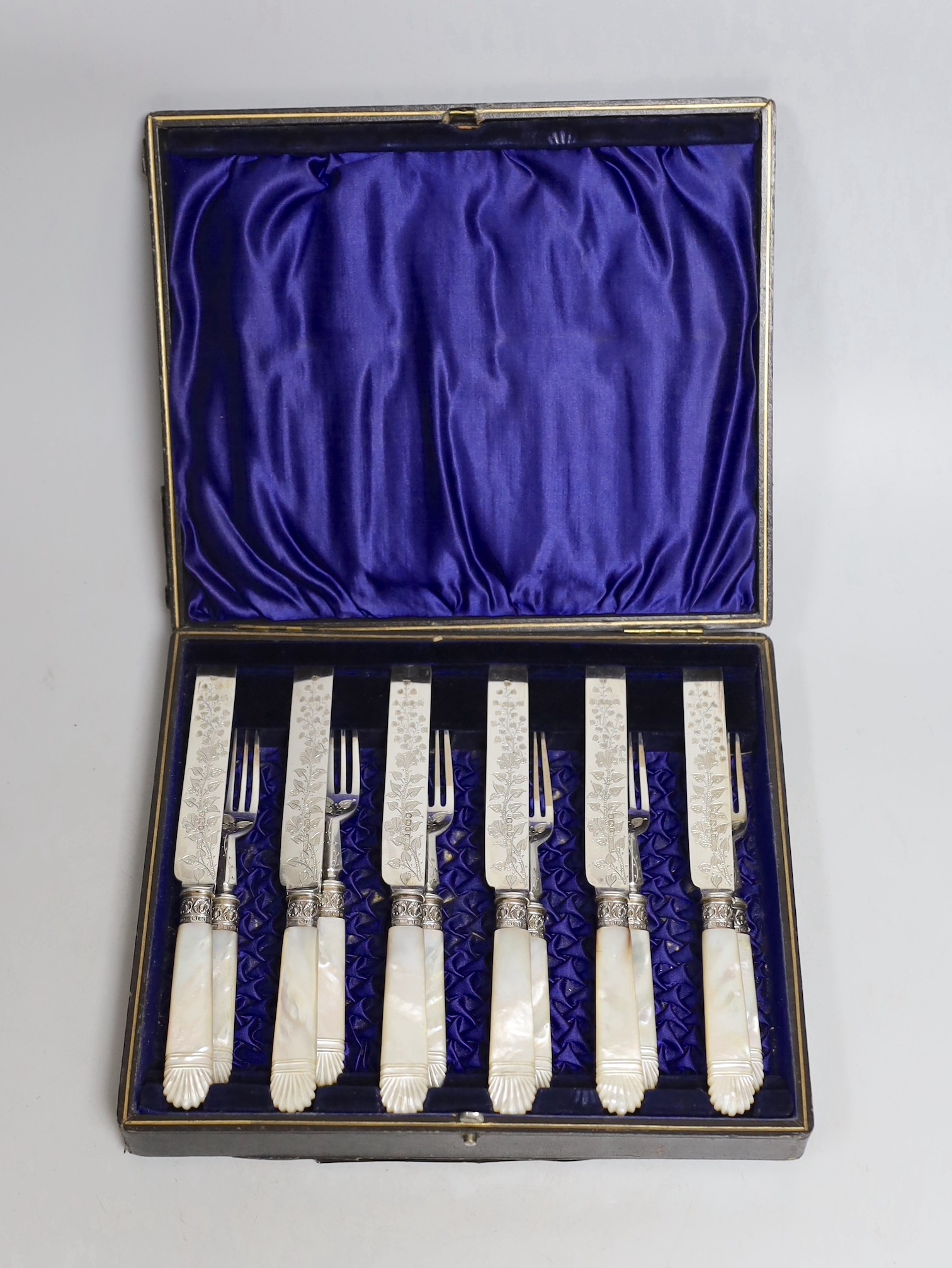 A cased set of six pairs of late Victorian mother of pearl handled silver dessert eaters, P. Ashberry & Sons, Sheffield, 1895.